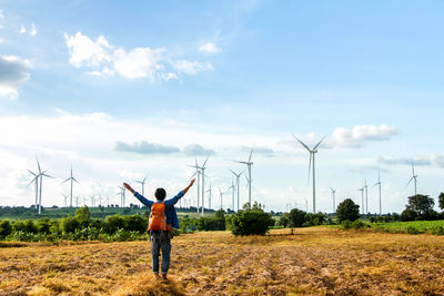 Man standing on field against sky