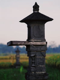 Close-up of cemetery on field against sky