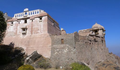 Low angle view of historic building against blue sky