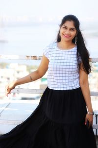 Portrait of a smiling young woman standing outdoors