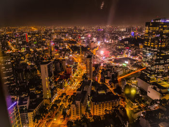 High angle view of illuminated city buildings at night