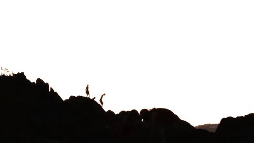 Silhouette of mountain against clear sky at sunset