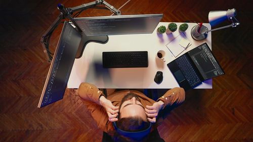 High angle view of man using digital tablet on table