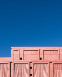 Low angle view of building against clear blue sky