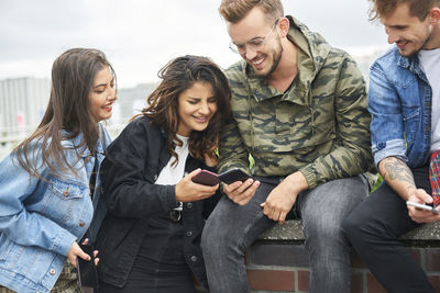 Young couple standing on mobile phone