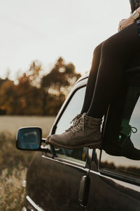 Reflection of man on side-view mirror