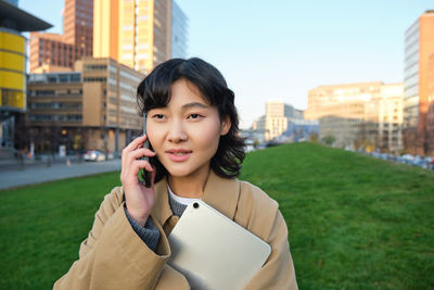 Portrait of young woman using mobile phone