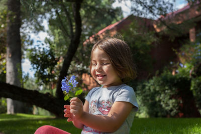 Portrait of smiling girl with pink flower