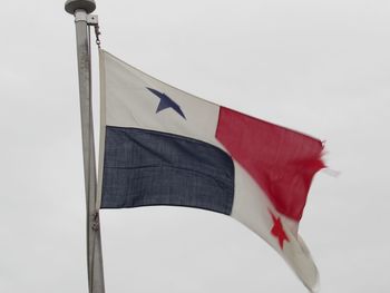 Low angle view of flag against clear sky