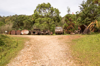 Abandoned train on field against sky