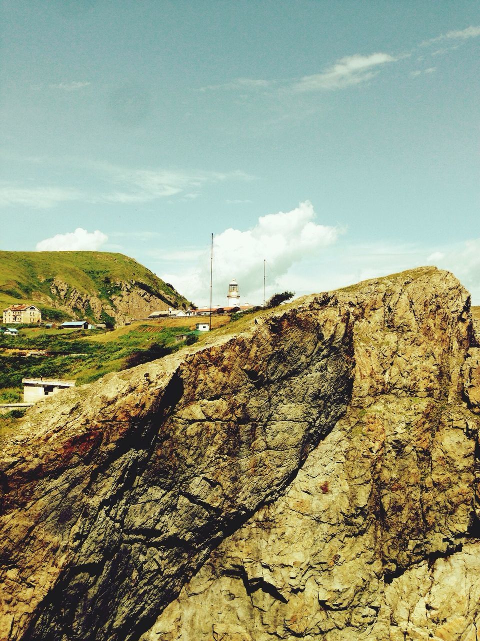 sky, landscape, cloud - sky, blue, cloud, tranquil scene, tranquility, mountain, rock - object, nature, scenics, beauty in nature, day, sunlight, rock formation, outdoors, non-urban scene, hill, remote, no people