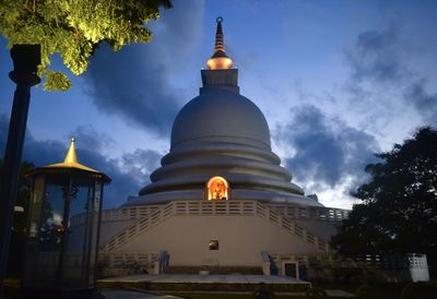 Low angle view of illuminated building against sky