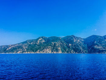 Scenic view of sea against blue sky