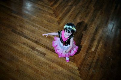 Girl standing on hardwood floor