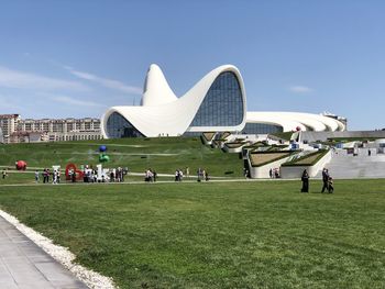 Group of people in front of built structure against sky