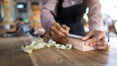 Midsection of woman preparing food on table