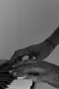 Cropped hands of person playing piano