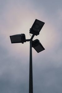 Low angle view of security camera against sky