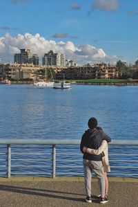 Rear view of woman looking at river