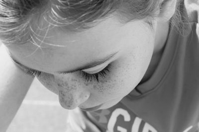 Close-up of teenage girl with freckle on her face