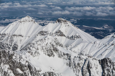 Aerial view of snow covered landscape against sky. view from lomnica, tatra mountains, poland