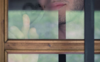 Portrait of woman seen through glass window