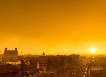 High angle view of buildings in city during sunset