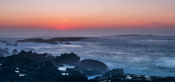 Scenic view of sea against sky during sunset