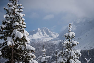 Scenic view of snow covered mountains against sky