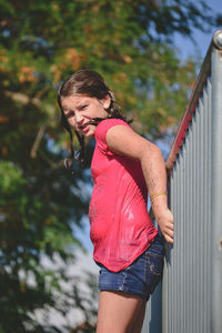 Woman standing by railing