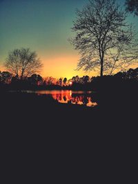 Silhouette trees against sky during sunset