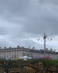 Low angle view of buildings against cloudy sky