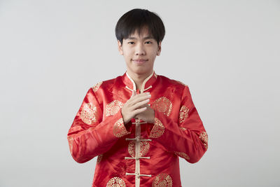 Portrait of a smiling young man against white background