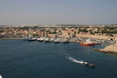 High angle view of sea and cityscape against sky