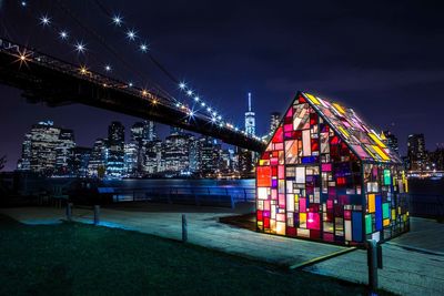 Illuminated buildings against sky at night