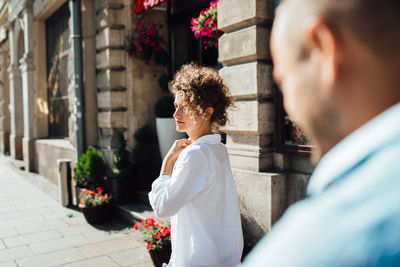 Side view of couple kissing on flower