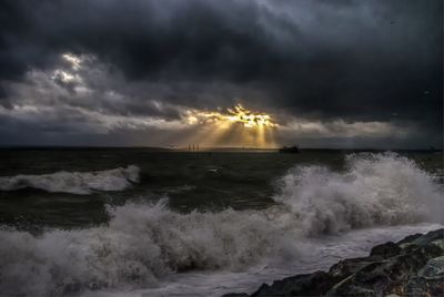 Scenic view of sea against storm clouds