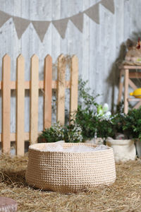 Close-up of wicker basket on table against building