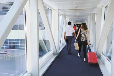 Rear view of woman standing in corridor