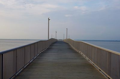 Pier over sea against sky