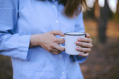 Close-up of woman holding coffee cup