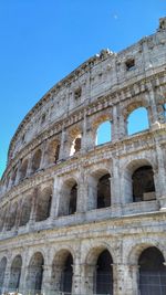 Low angle view of historical building against clear blue sky