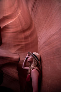 Close-up of woman standing against rock formation