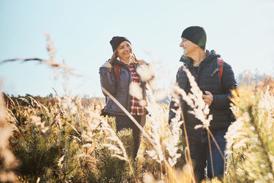 Couple having fun while vacation trip. hikers with backpacks on way to mountains