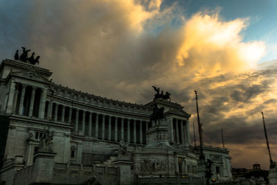 Low angle view of building against cloudy sky