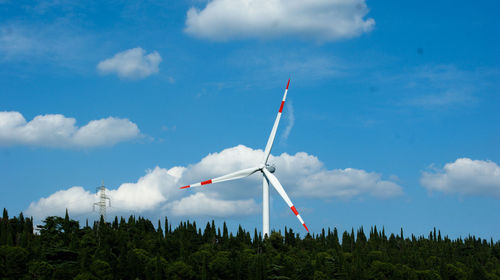 Low angle view of windmill against sky