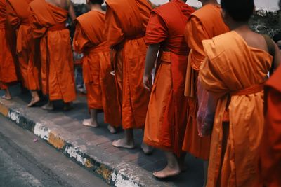 Low section of people walking on street