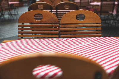 Close-up of chairs on table