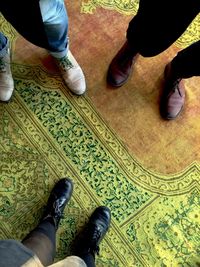 Low section of men standing on floor