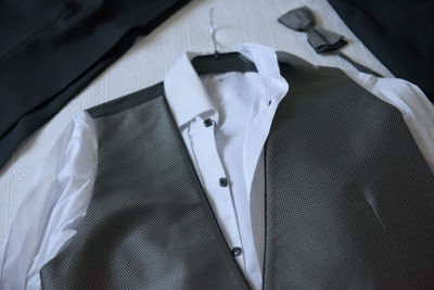 High angle view of waistcoat and shirt on table